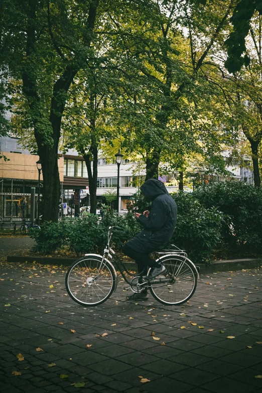 a person riding a bike on the sidewalk