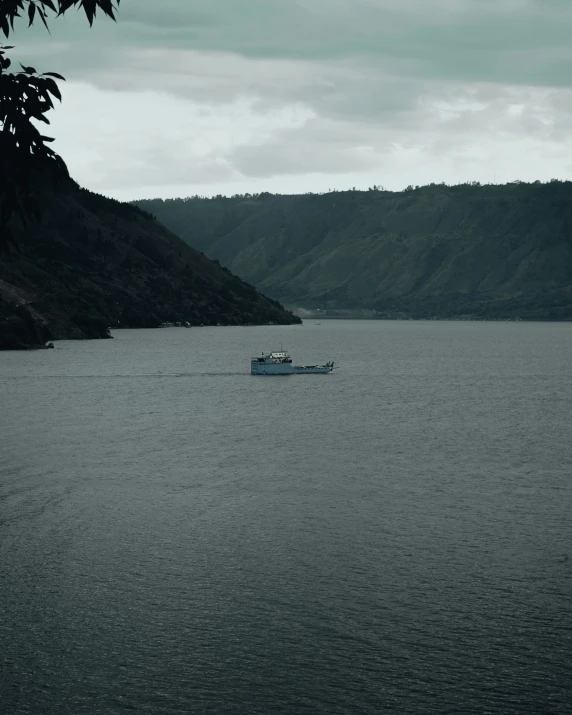 the boat is travelling along the water in the fog