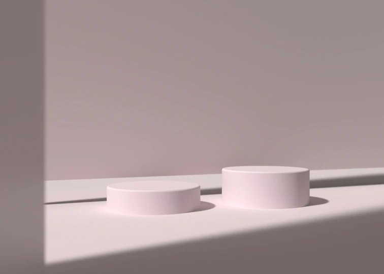 two minimalist pieces sit on a white surface