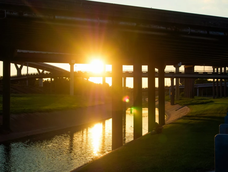 a body of water with a bridge and walkway to the river