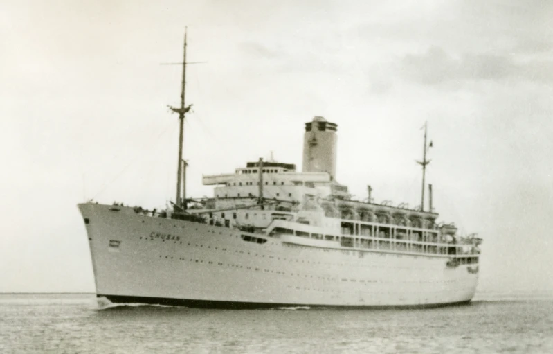 a large ship sailing in the ocean in a hazy day