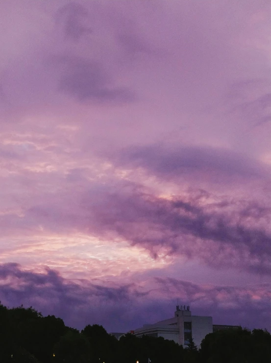 the view of the trees and clouds from the park