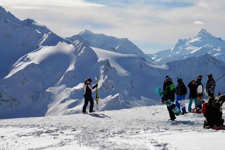 group of people on top of snowy mountains