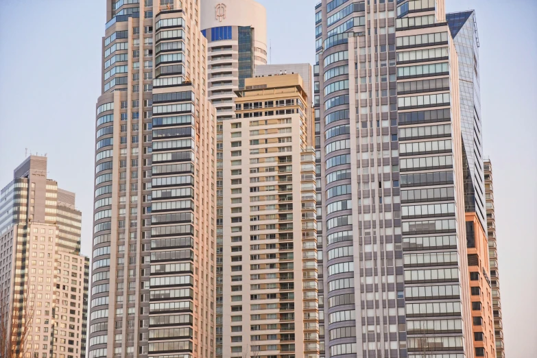 a group of tall buildings that are by a street