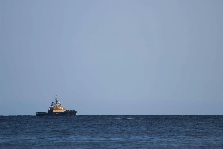 a small boat sailing across the ocean on a sunny day