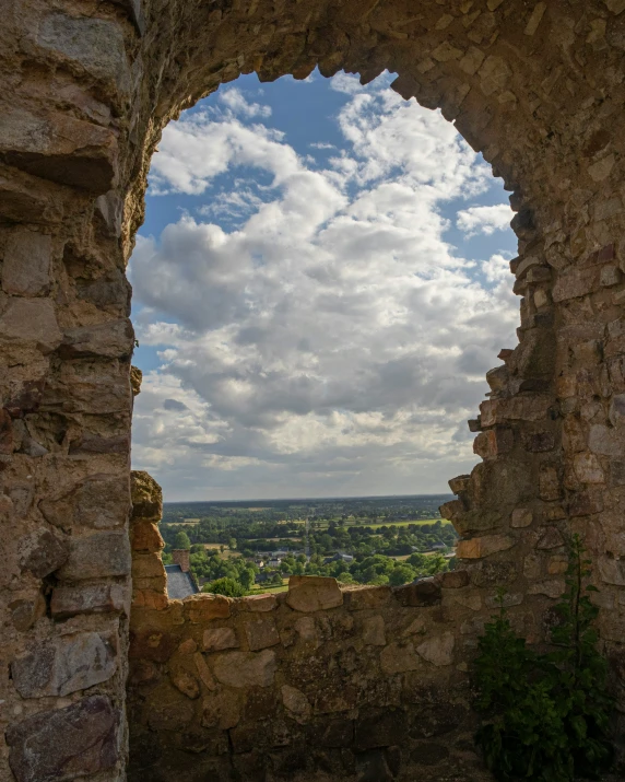 a window in an old castle overlooking the hills