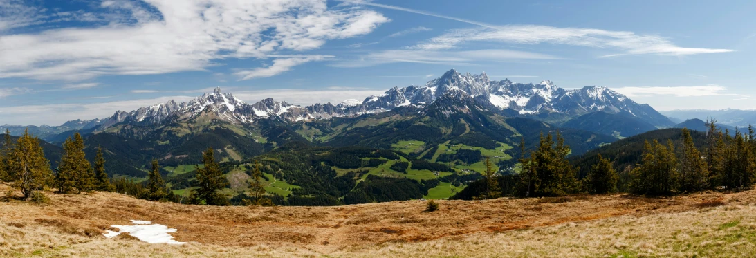 a large mountain range with a path leading into the distance