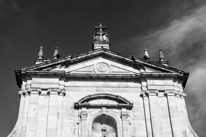 a building that has a clock and two birds on top