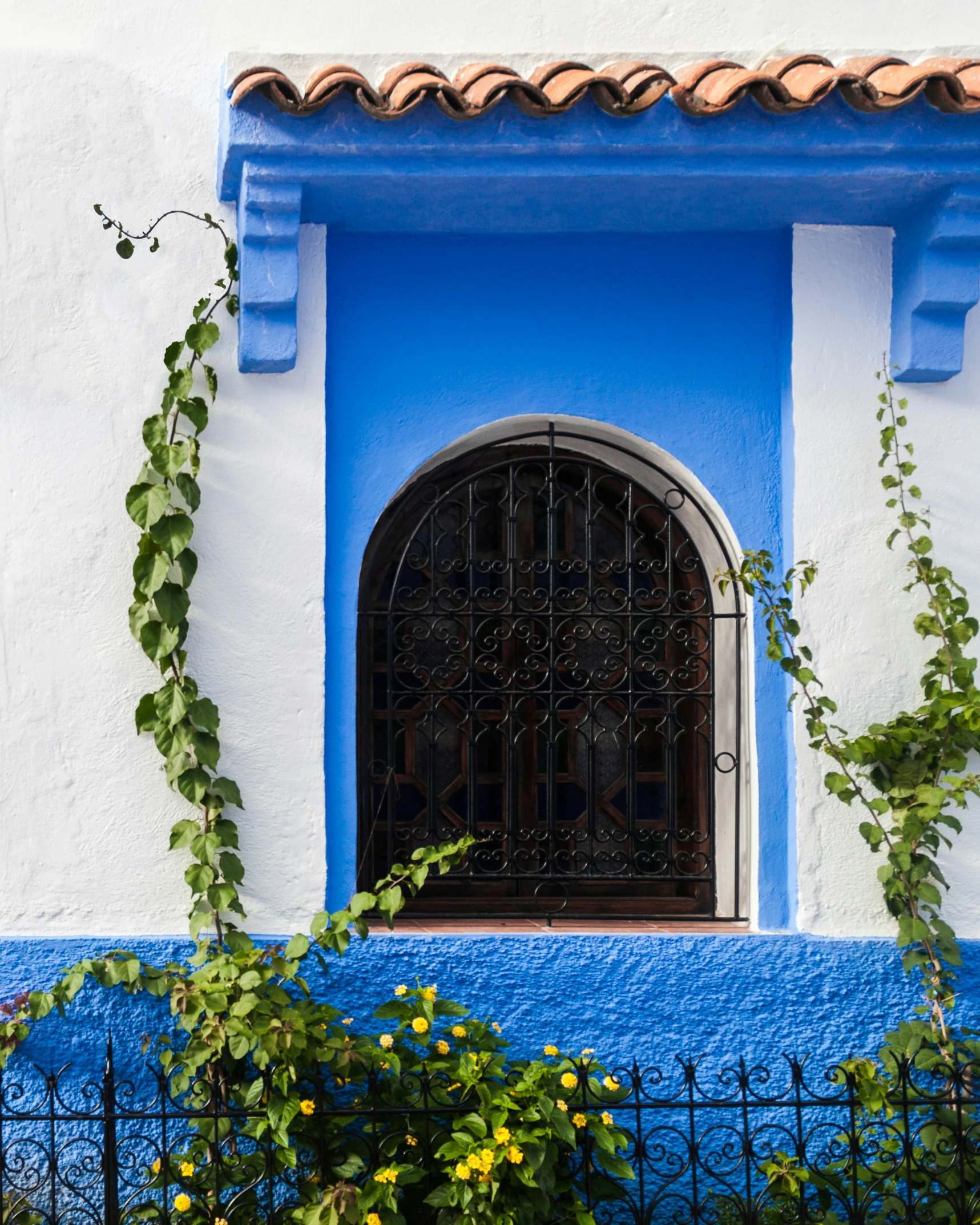 the building has a blue wall and an open window