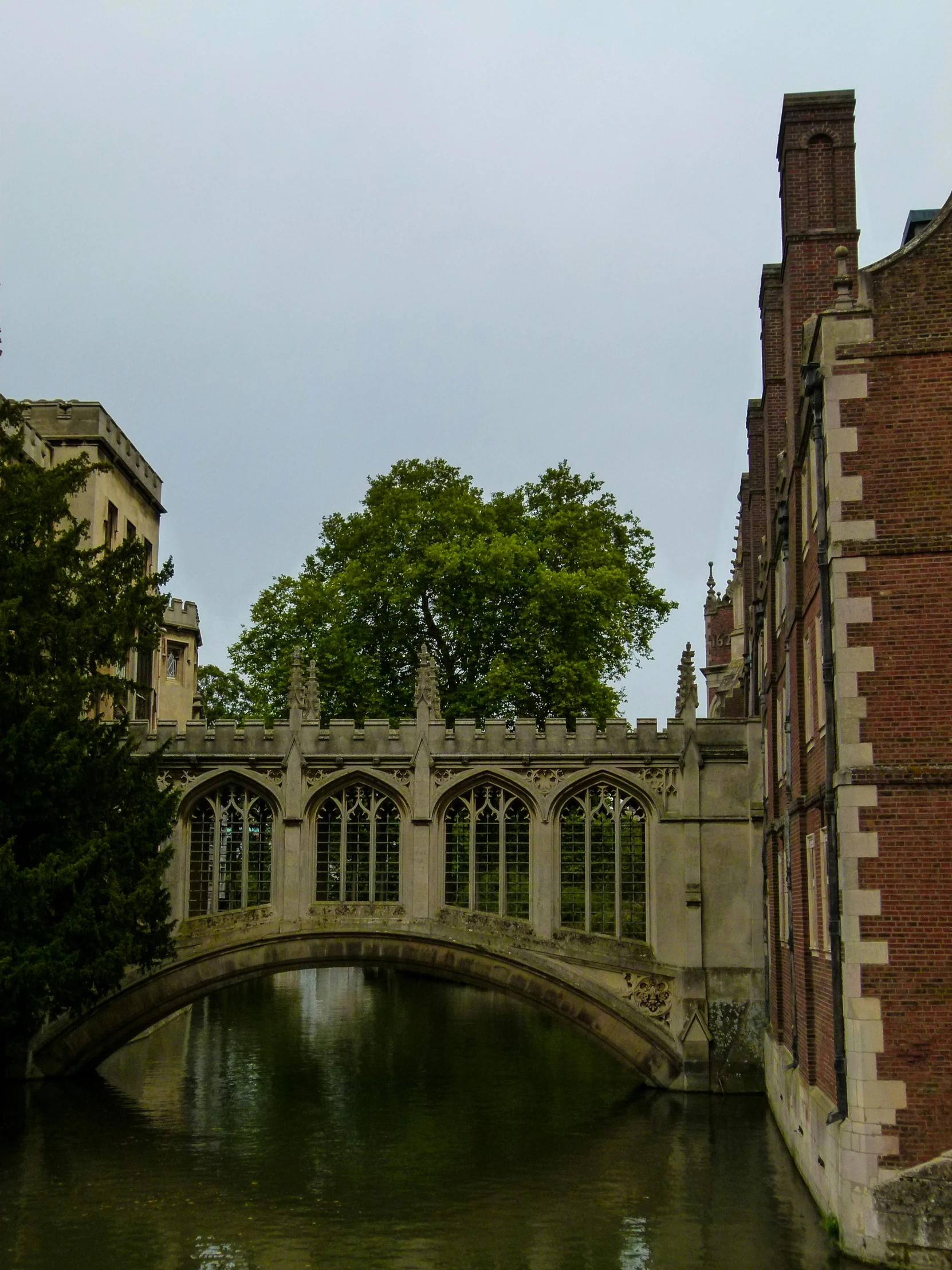 a bridge that is over some water and on a pole