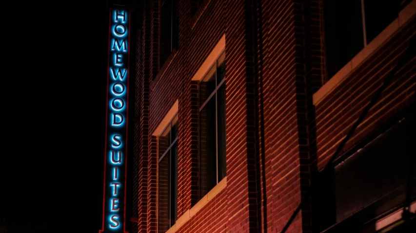 this neon sign is lit up outside a building