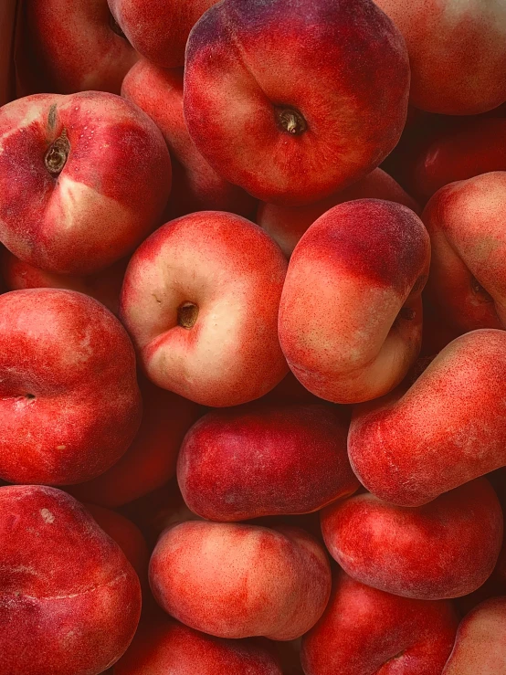 a lot of red and yellow fruit is laying together