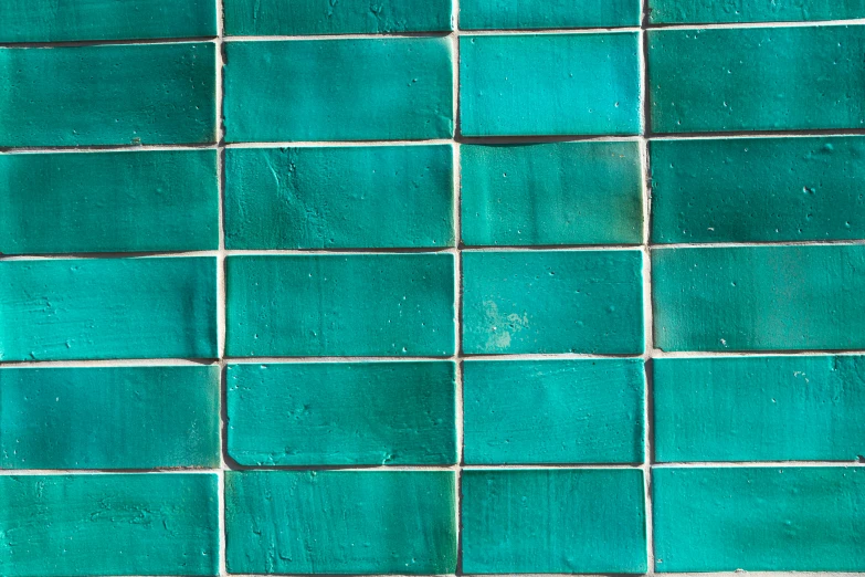 several different shapes and colors of turquoise colored tile