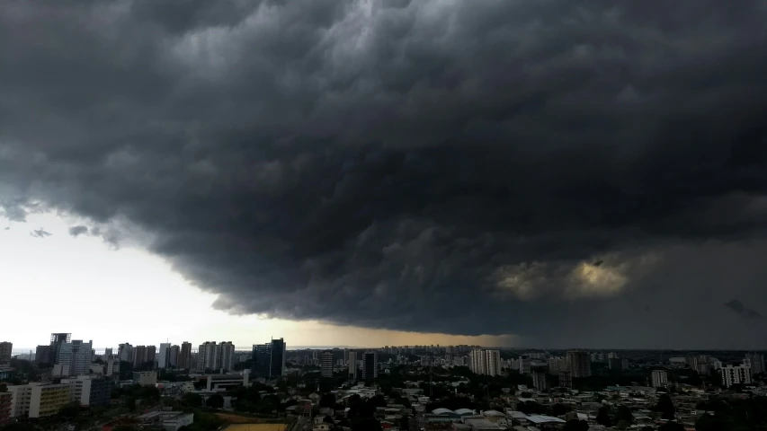 an aerial view of city skylines and dark clouds