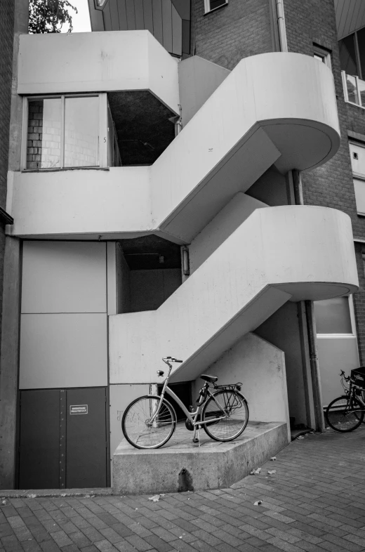 two bicycles parked in front of a building