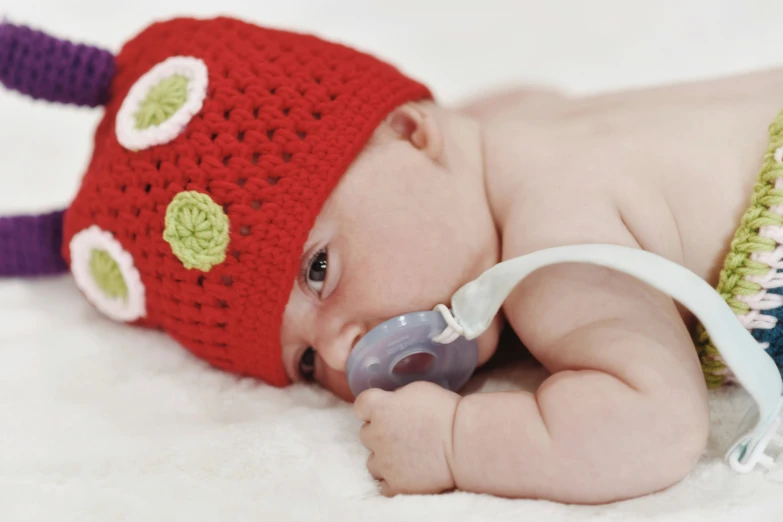 a baby wearing a crocheted hat on its head