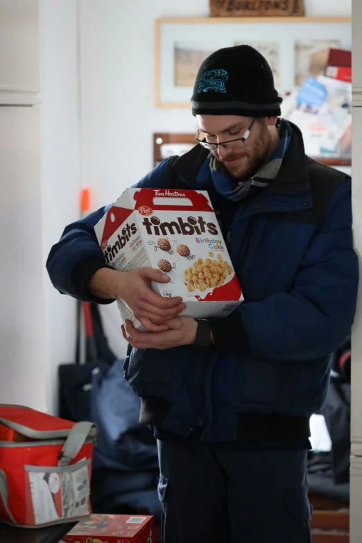 a man is reading a box of cereal