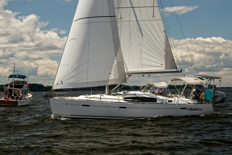 two sailboats in the water near one another