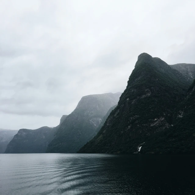 a couple of large mountains next to the water