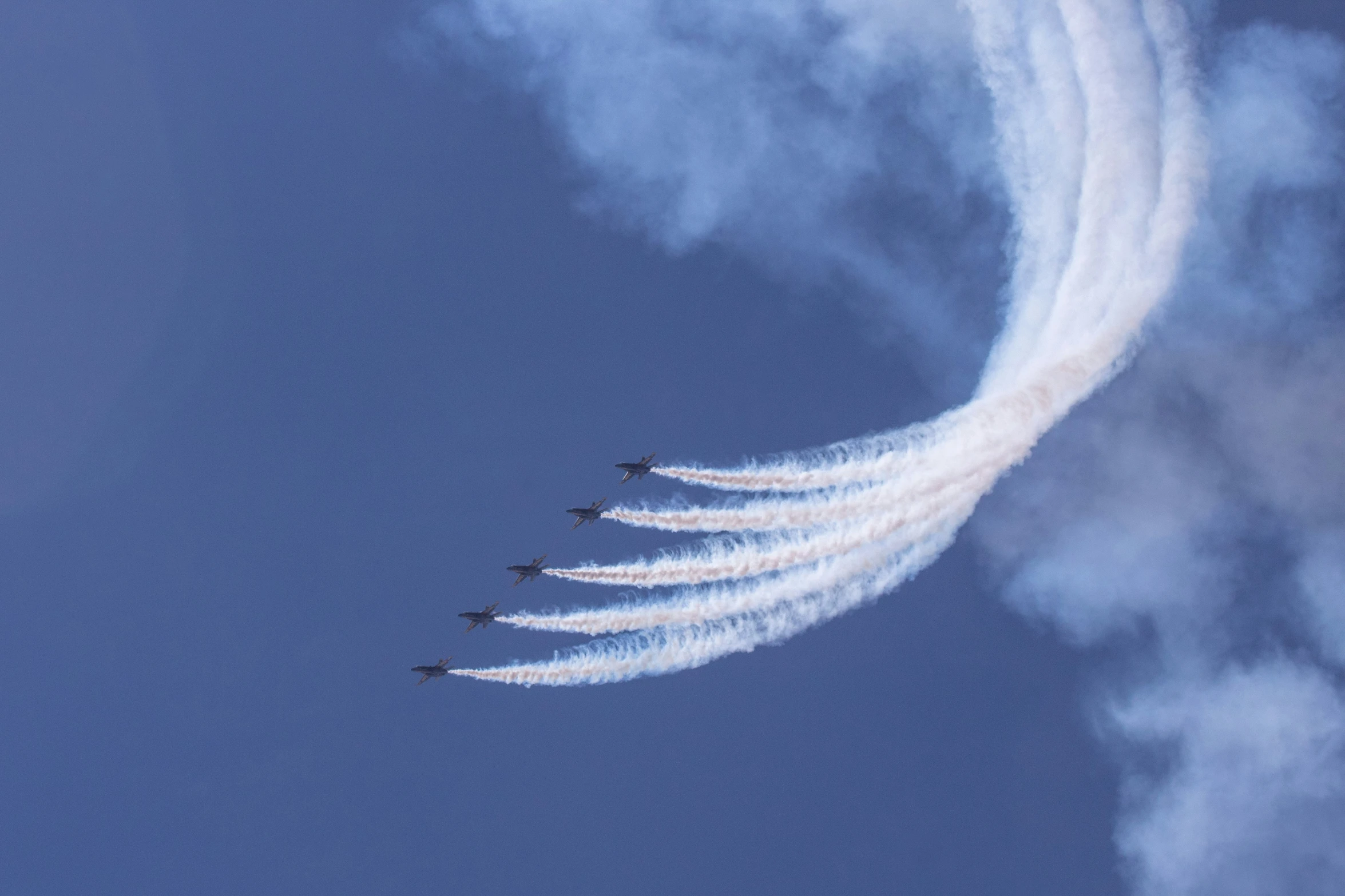 a number of planes flying through the air