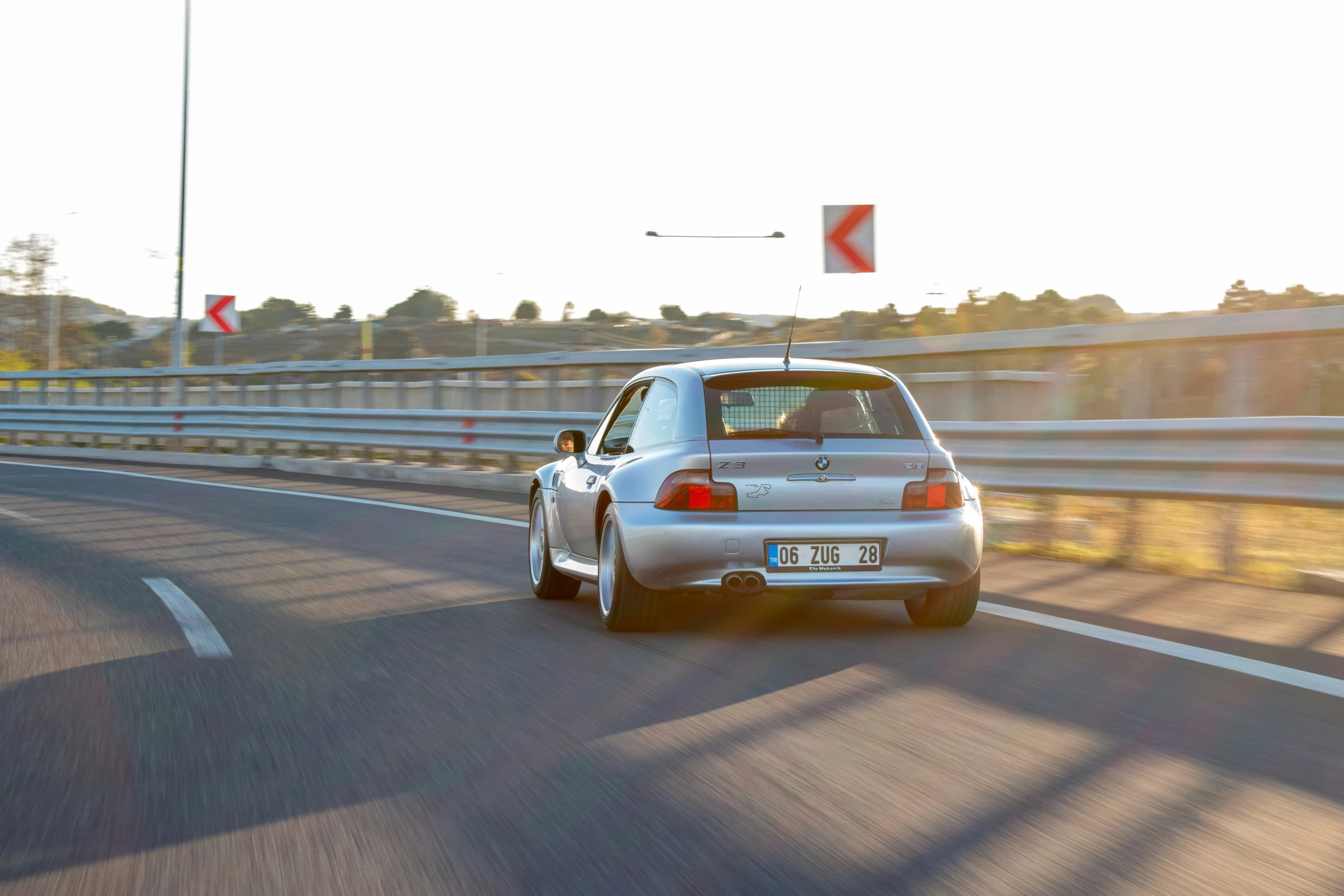 a white car driving on the road