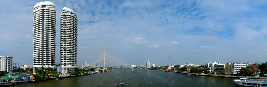 the tall buildings on the river are designed like a tower