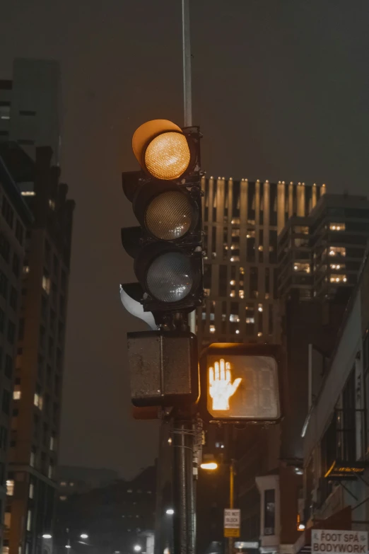 the signal light is above an intersection at night