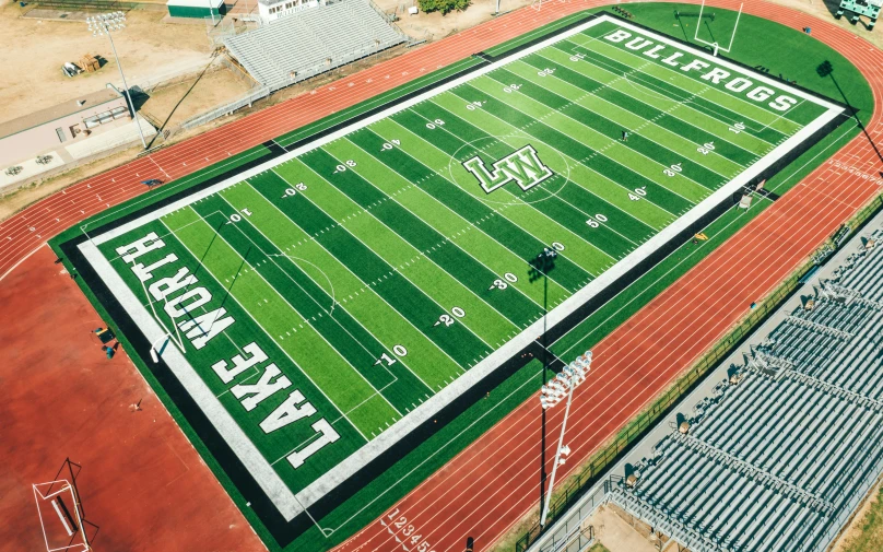 a large football stadium with some dirt field