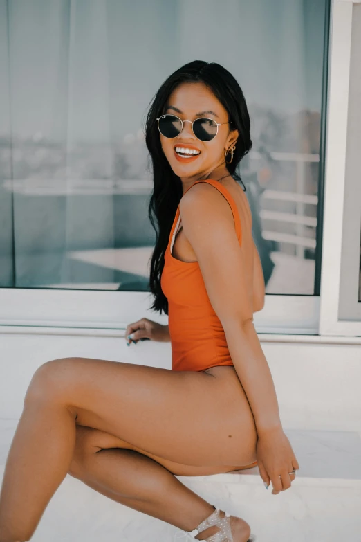 a young woman sitting outside wearing sun glasses