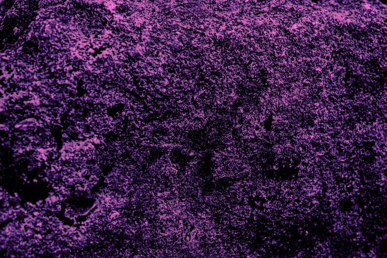 a grungy texture of a stone with a purple hue