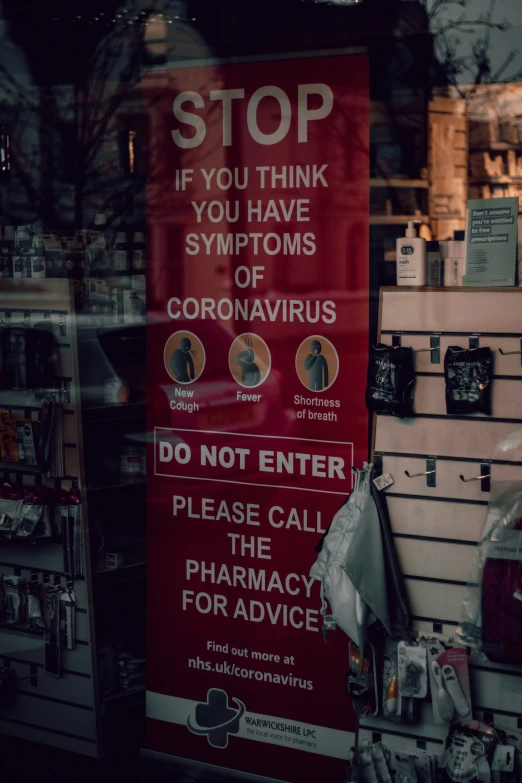 a pharmacy shop sign posted in the window