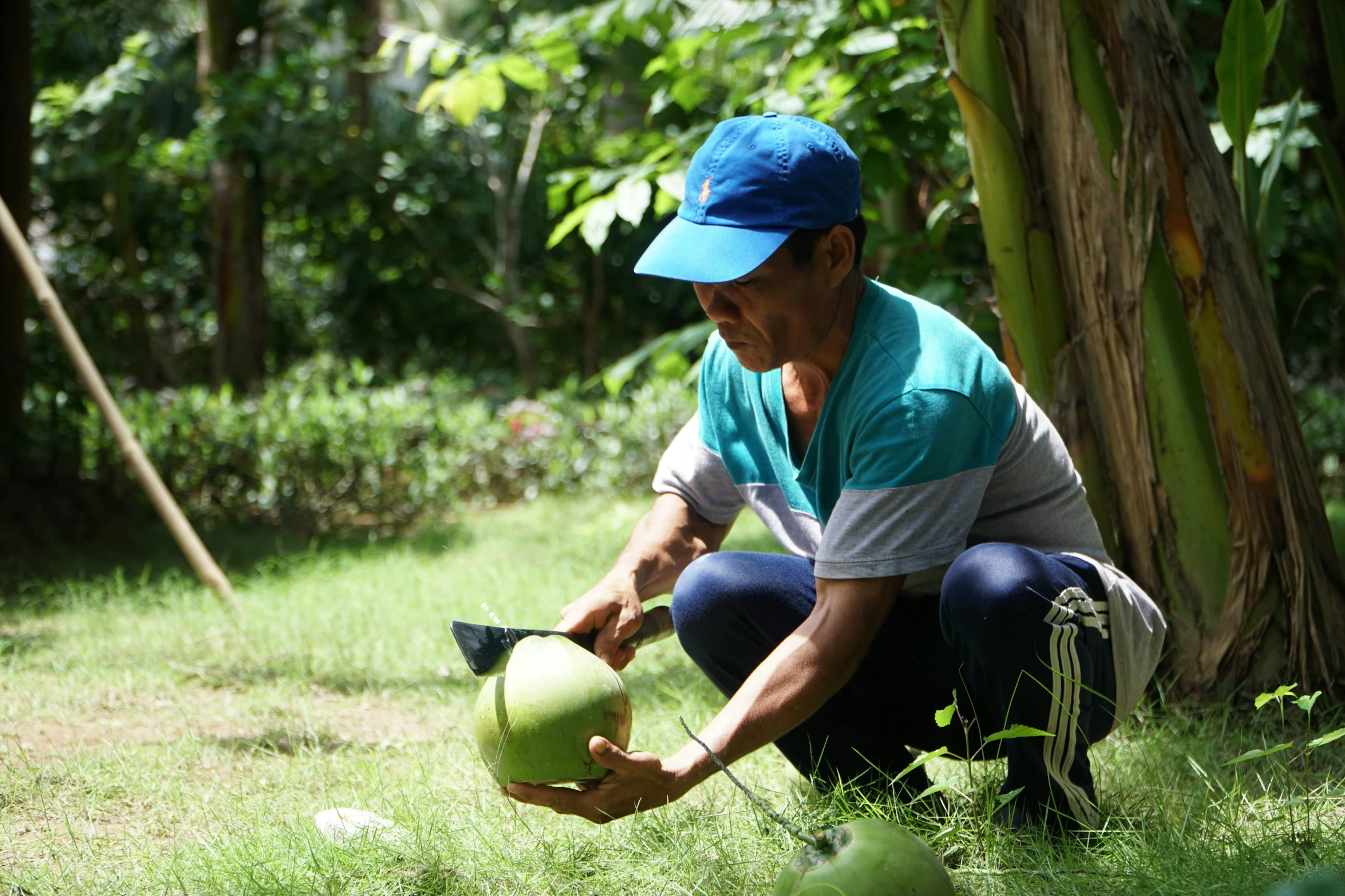 a man bending down holding a green apple