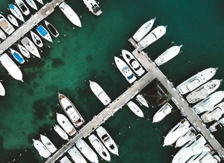 a harbor full of docked boats under a sky