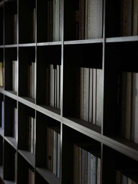 a number of books on shelves with one lit from below