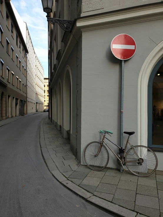 the bike is parked near the building's entrance