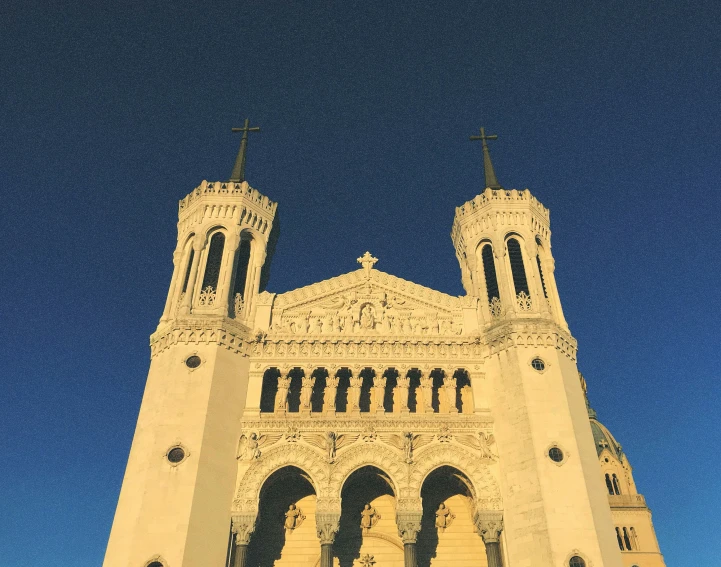 a large white church building with two towers