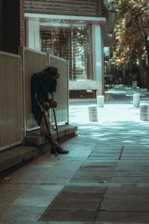 a person on a sidewalk with a cane