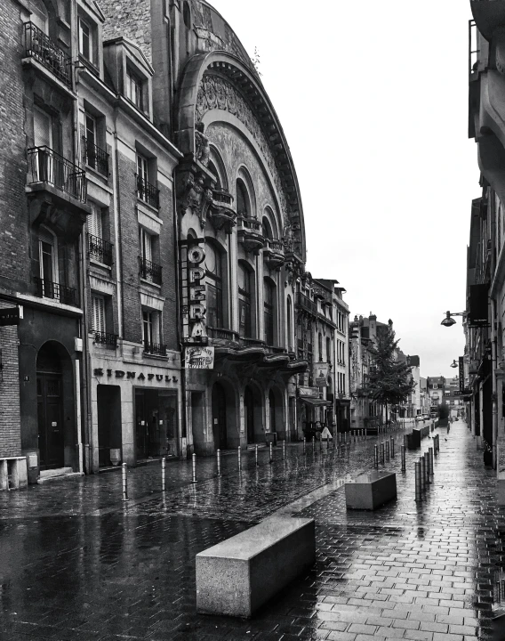 black and white pograph of a city with rain on it