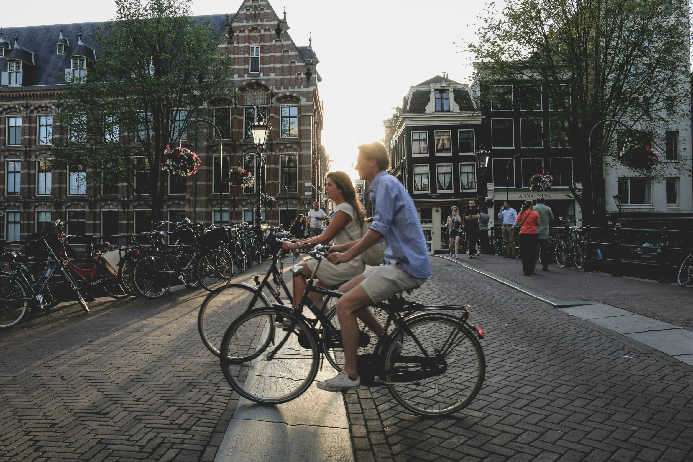 the couple rides their bikes on the bricked walkway