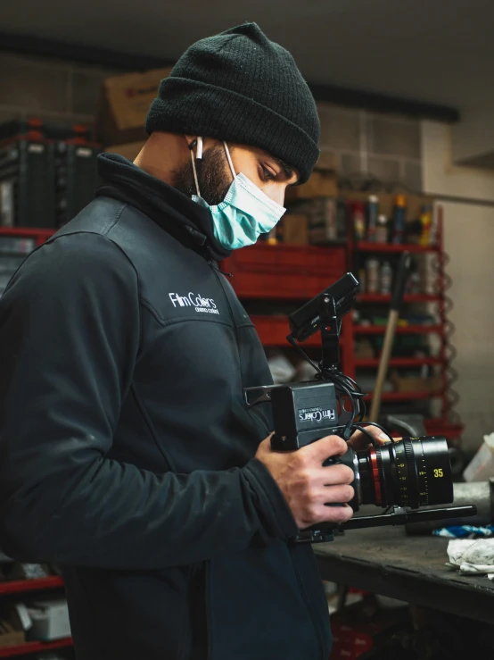 a man in a mask with a camera in his hand