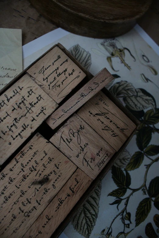 a couple of pieces of wood with handwriting on it