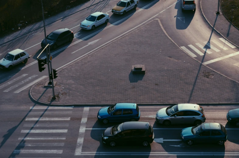 some cars on a busy road with a traffic light