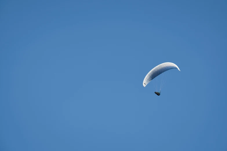 a man is para sailing through the clear blue sky