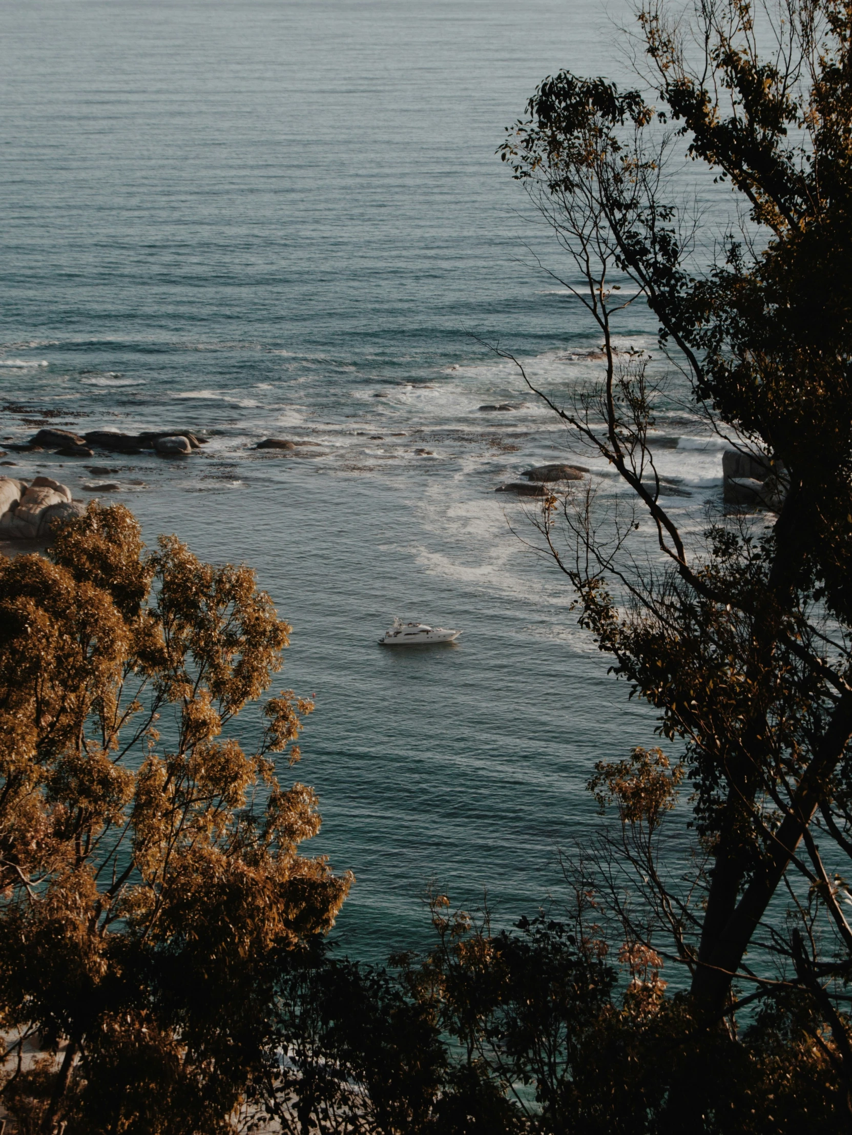 a lighthouse sitting on top of a lush green hillside