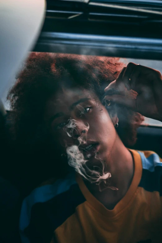 a young man smoking soing in his car