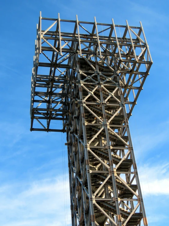 a tall metal structure under a cloudy blue sky