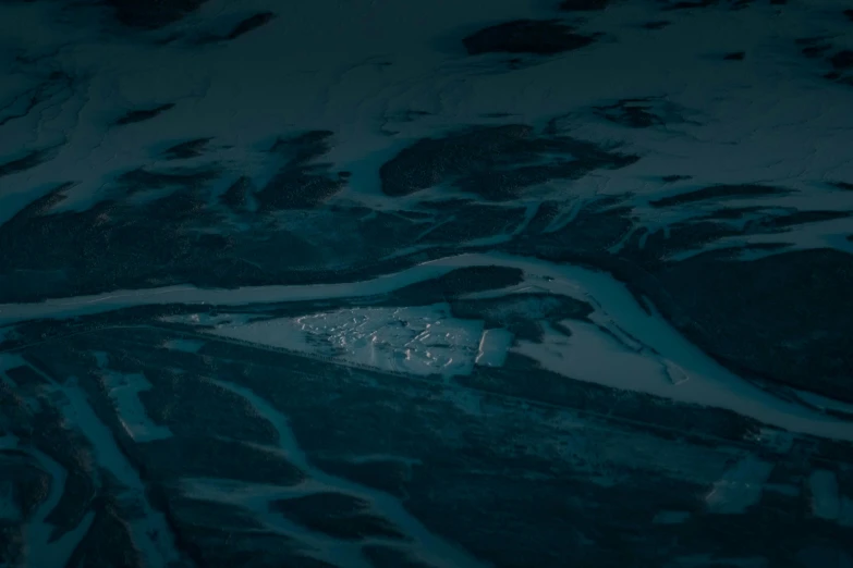 the aerial view of snow covered mountains and plains