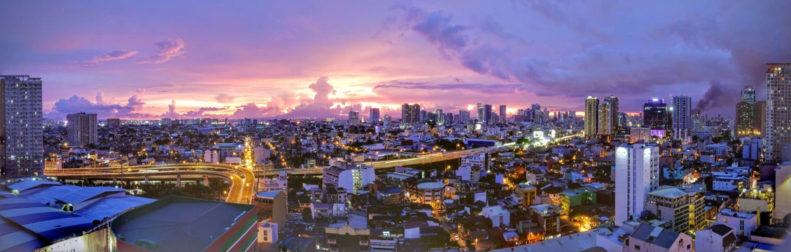 a view of city skyline at twilight, with the buildings lit up