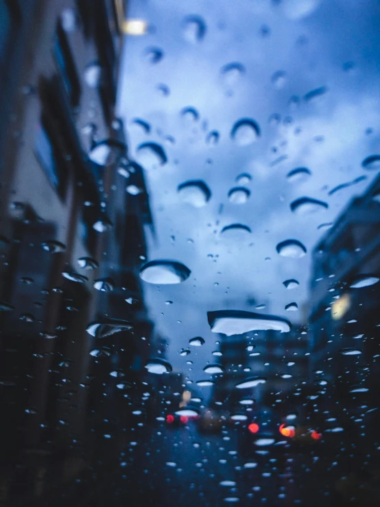 raindrops hanging over the side of cars on a city street