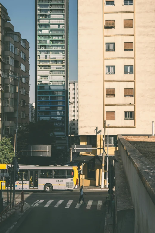 two buses parked in a parking lot near buildings